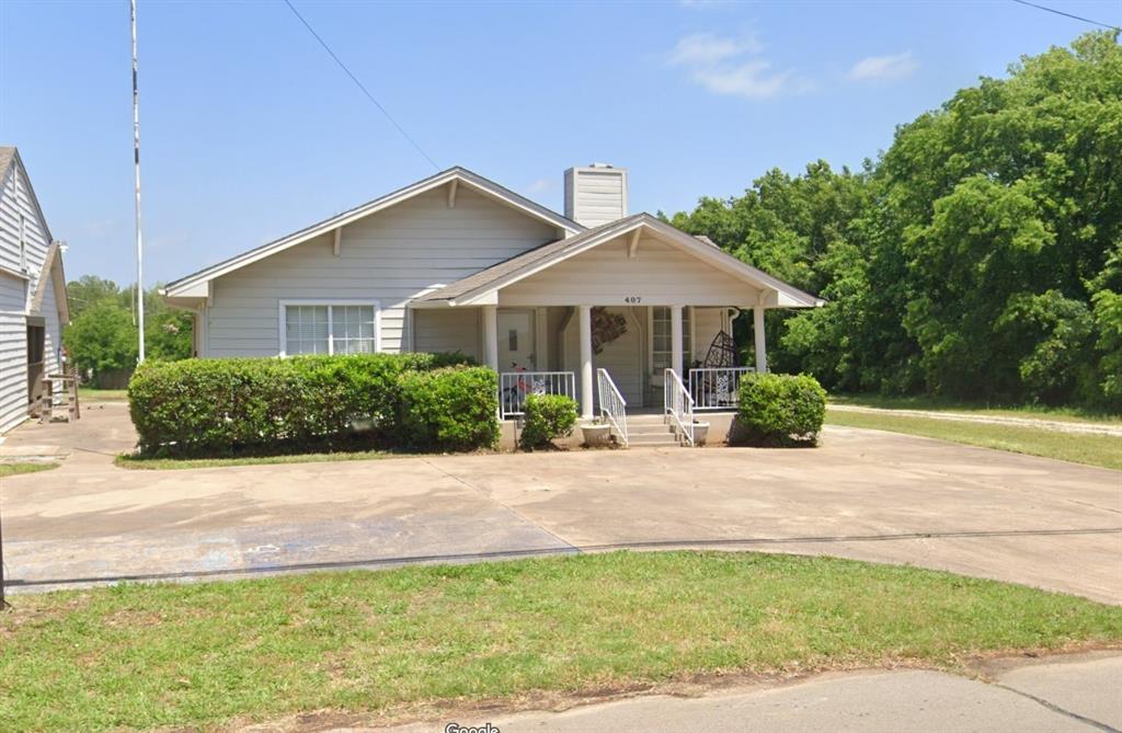 a front view of a house with yard and green space