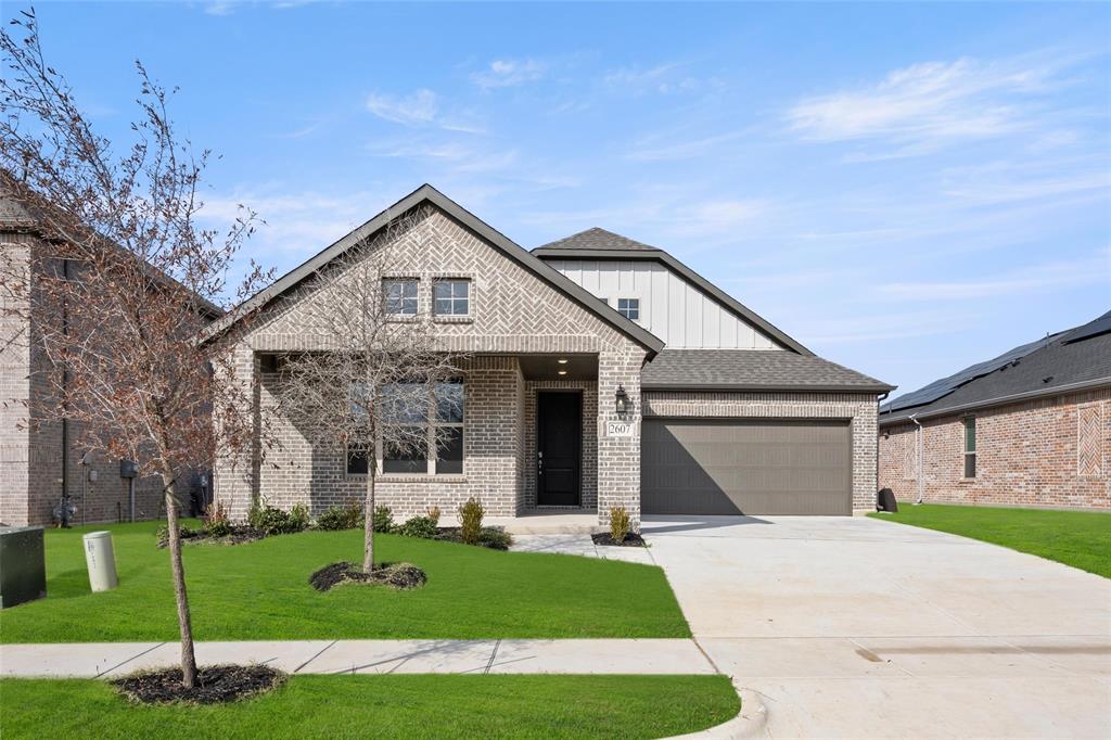 a front view of a house with a yard and garage