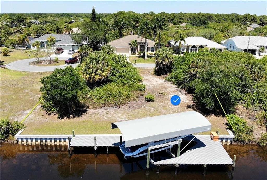 a view of a house with pool and chairs