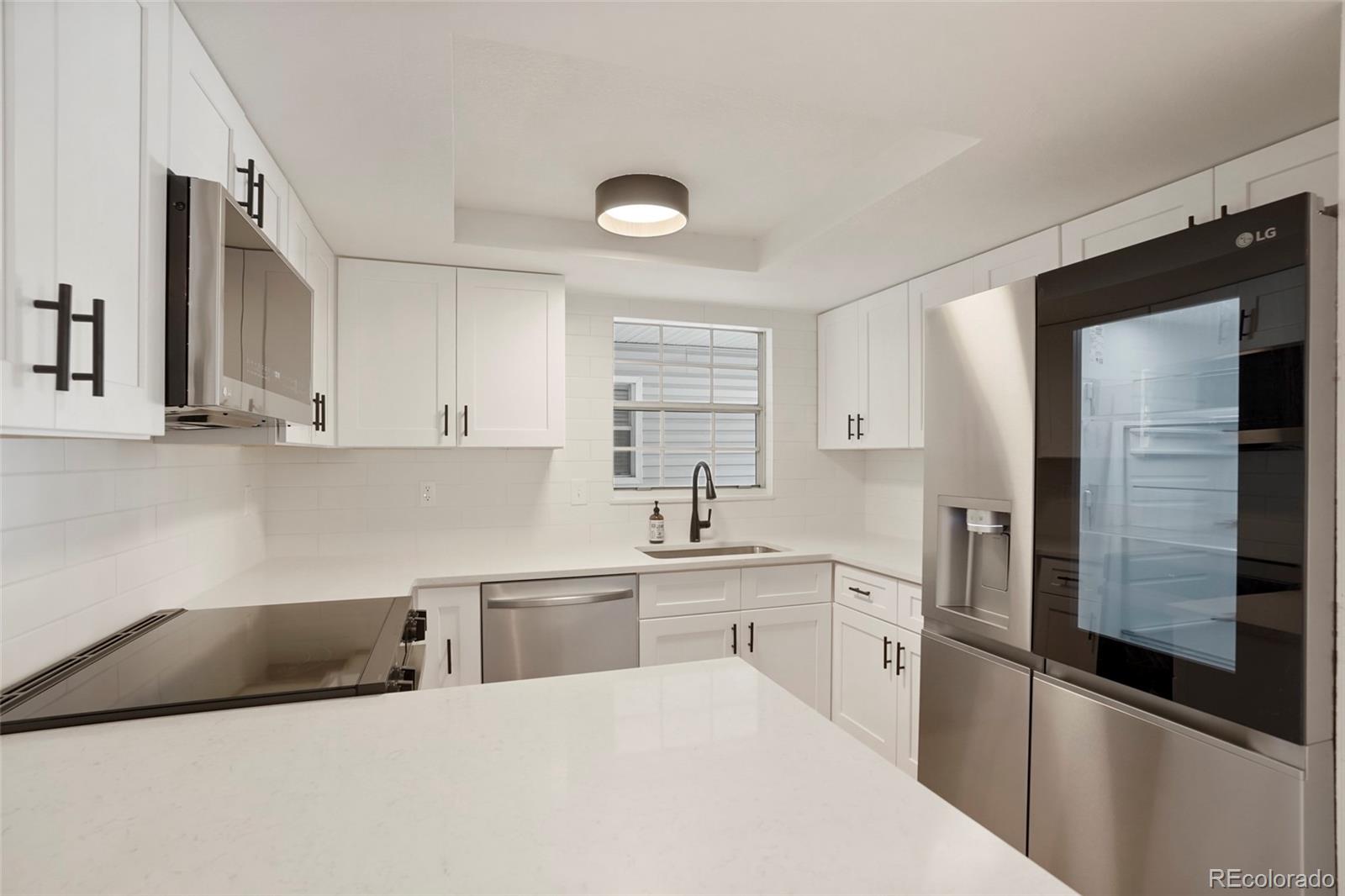 a kitchen with a sink stainless steel appliances and cabinets