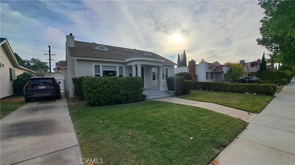 a front view of a house with a garden