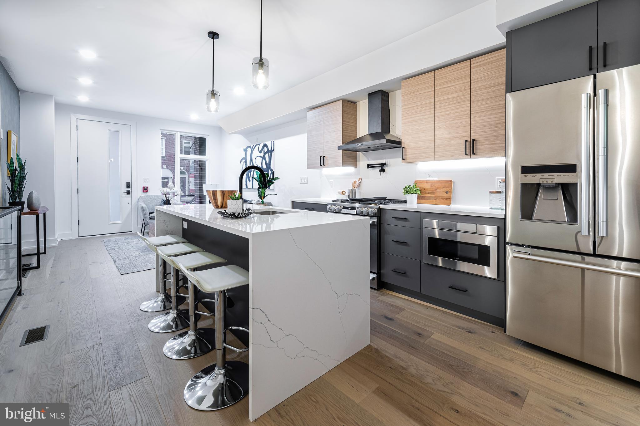 a kitchen with a sink stainless steel appliances and white cabinets