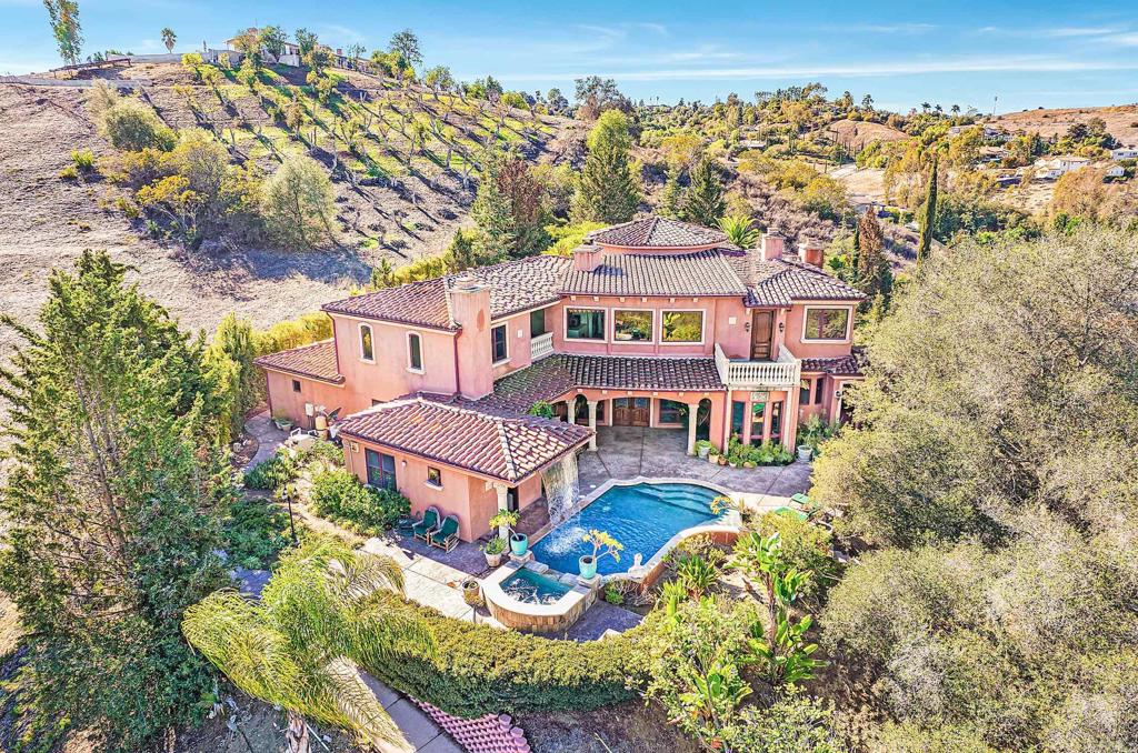 an aerial view of a house with a big yard