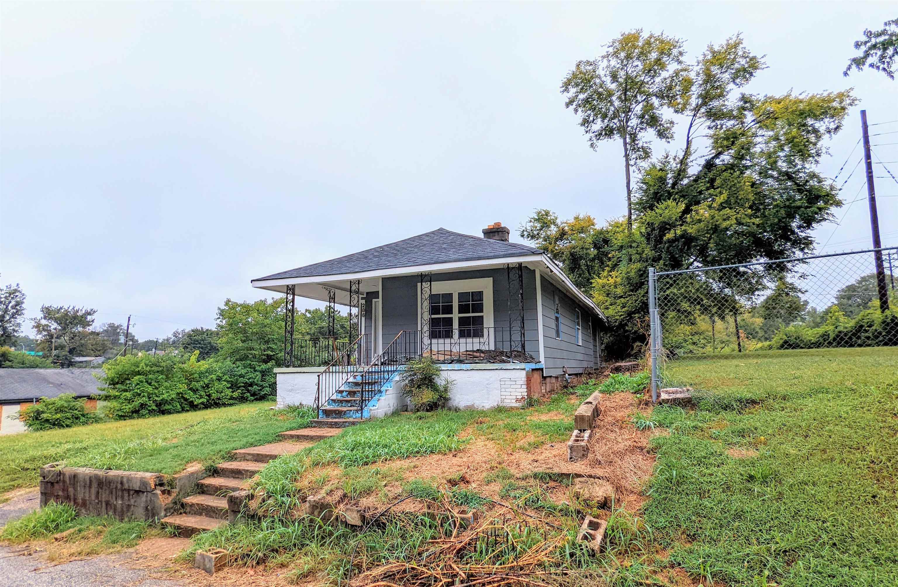 a front view of house with yard and trees