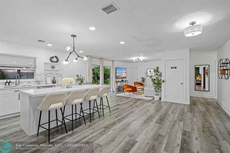 a large kitchen with a table and chairs