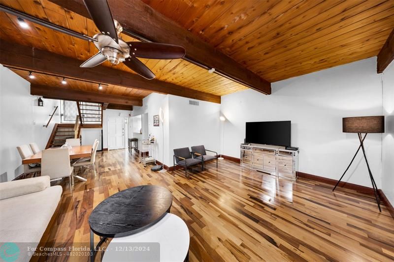 a bedroom with furniture and a flat screen tv