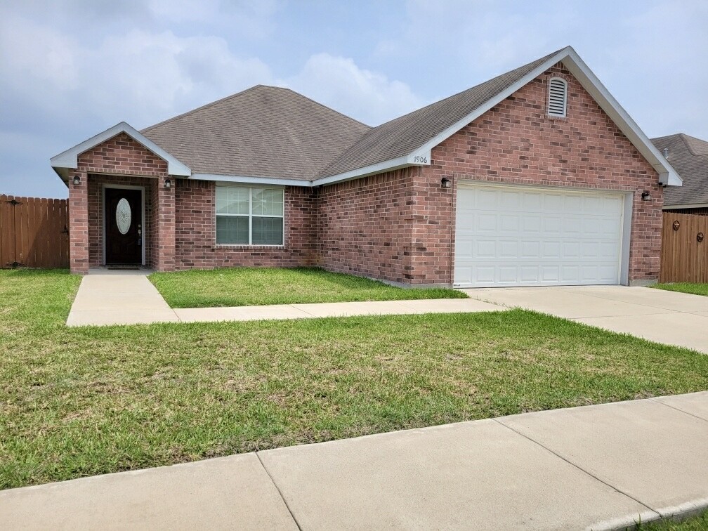 a view of a house with a yard and garage