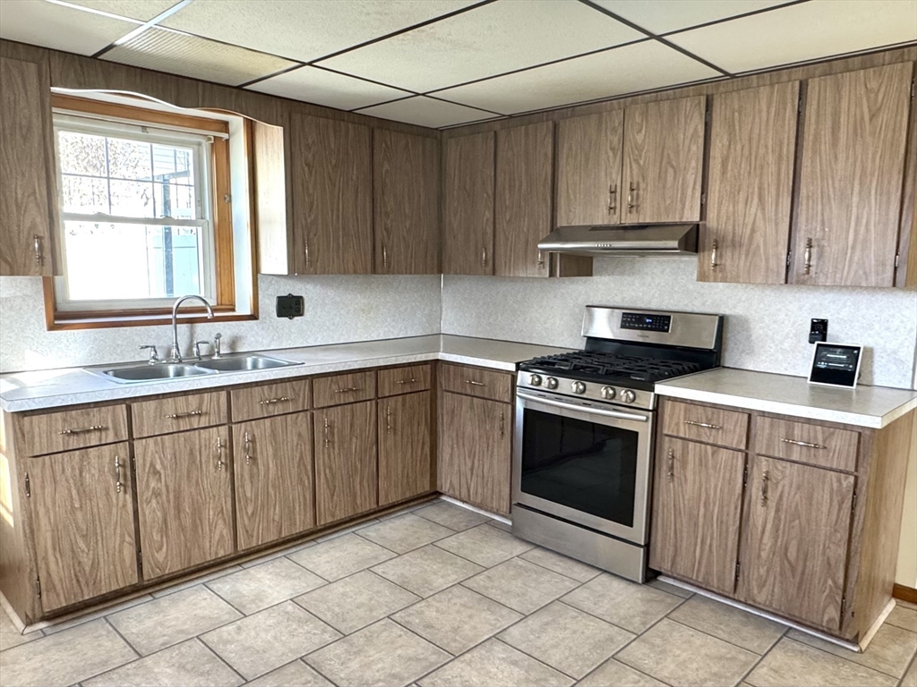 a kitchen with stainless steel appliances granite countertop a sink and cabinets