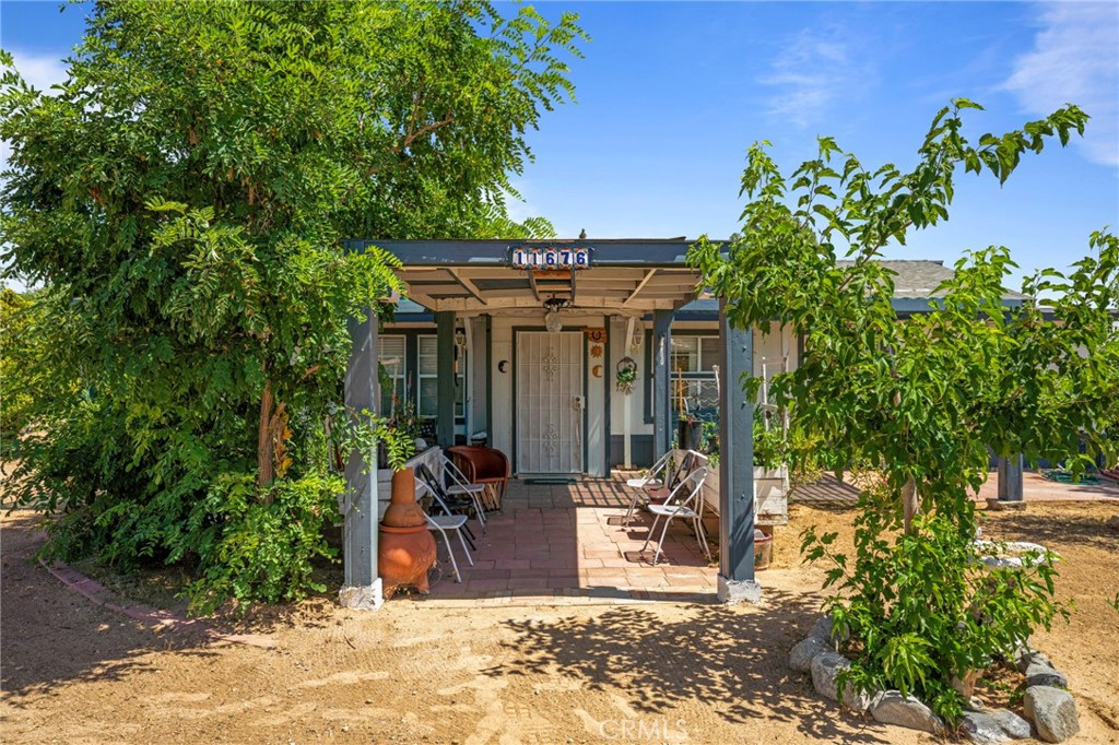 a view of a patio with table and chairs and potted plants