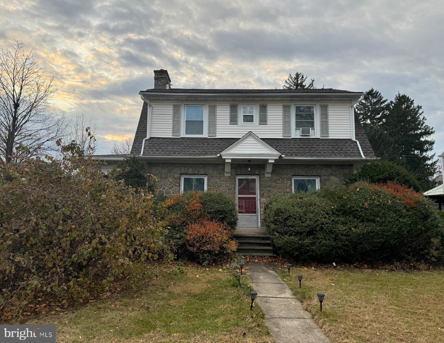 a front view of a house with garden