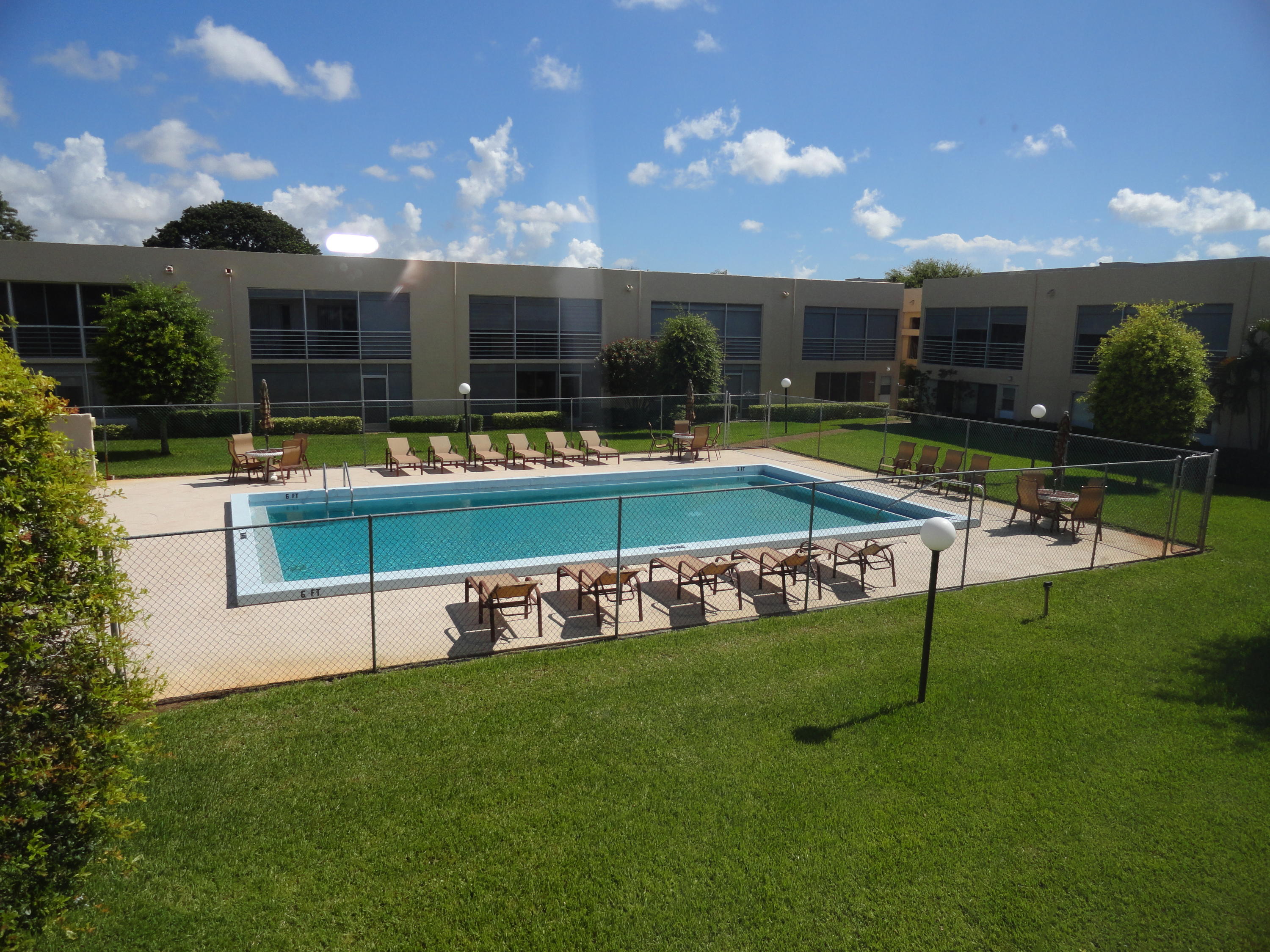 a view of a house with swimming pool and yard