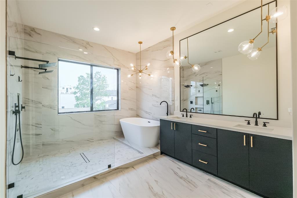 a spacious bathroom with a double vanity sink toilet mirror and bathtub