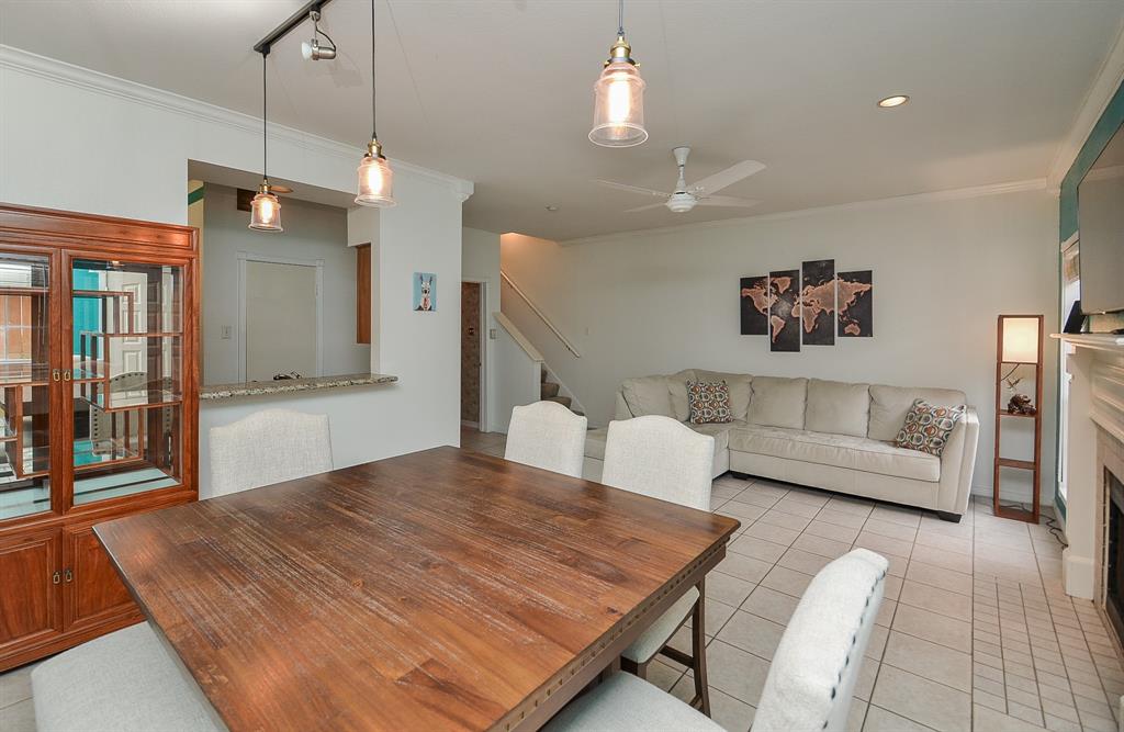 a spacious bedroom with a bed a couch and a chandelier