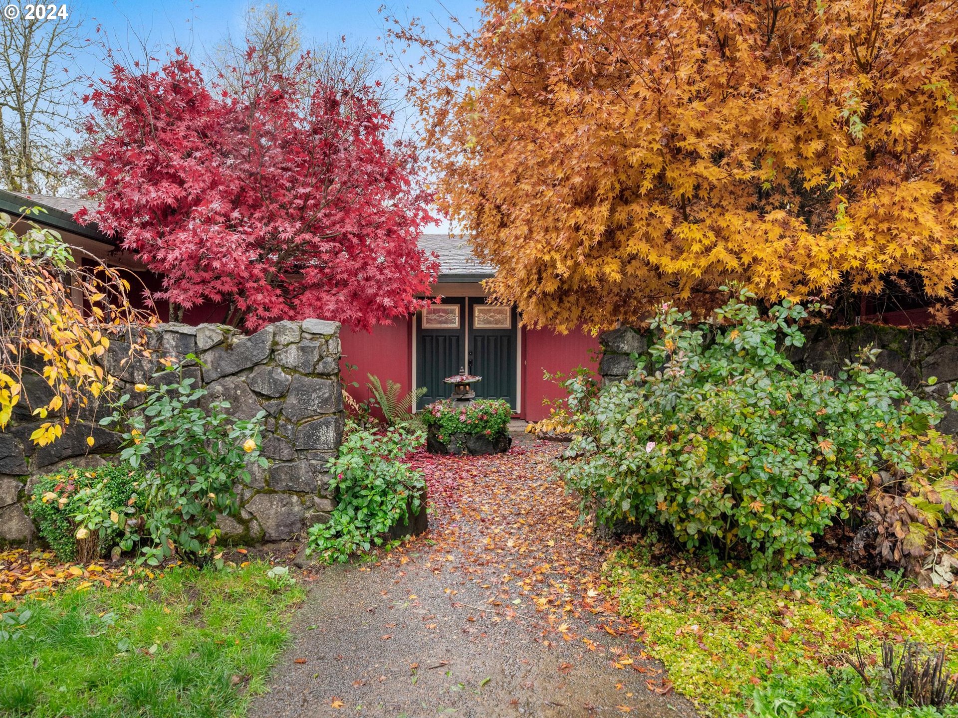 a front view of a house with a tree