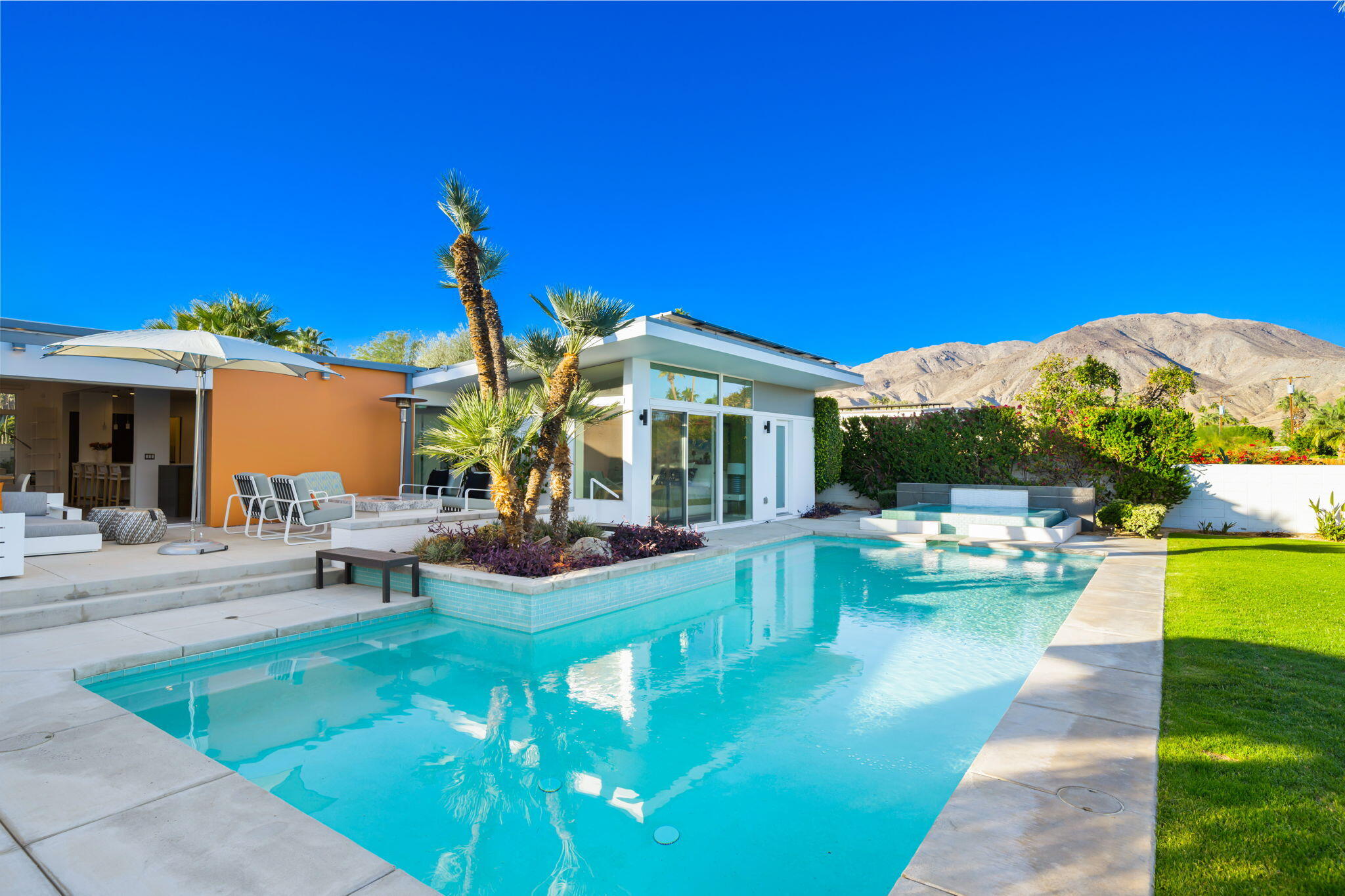 a view of a house with swimming pool and sitting area