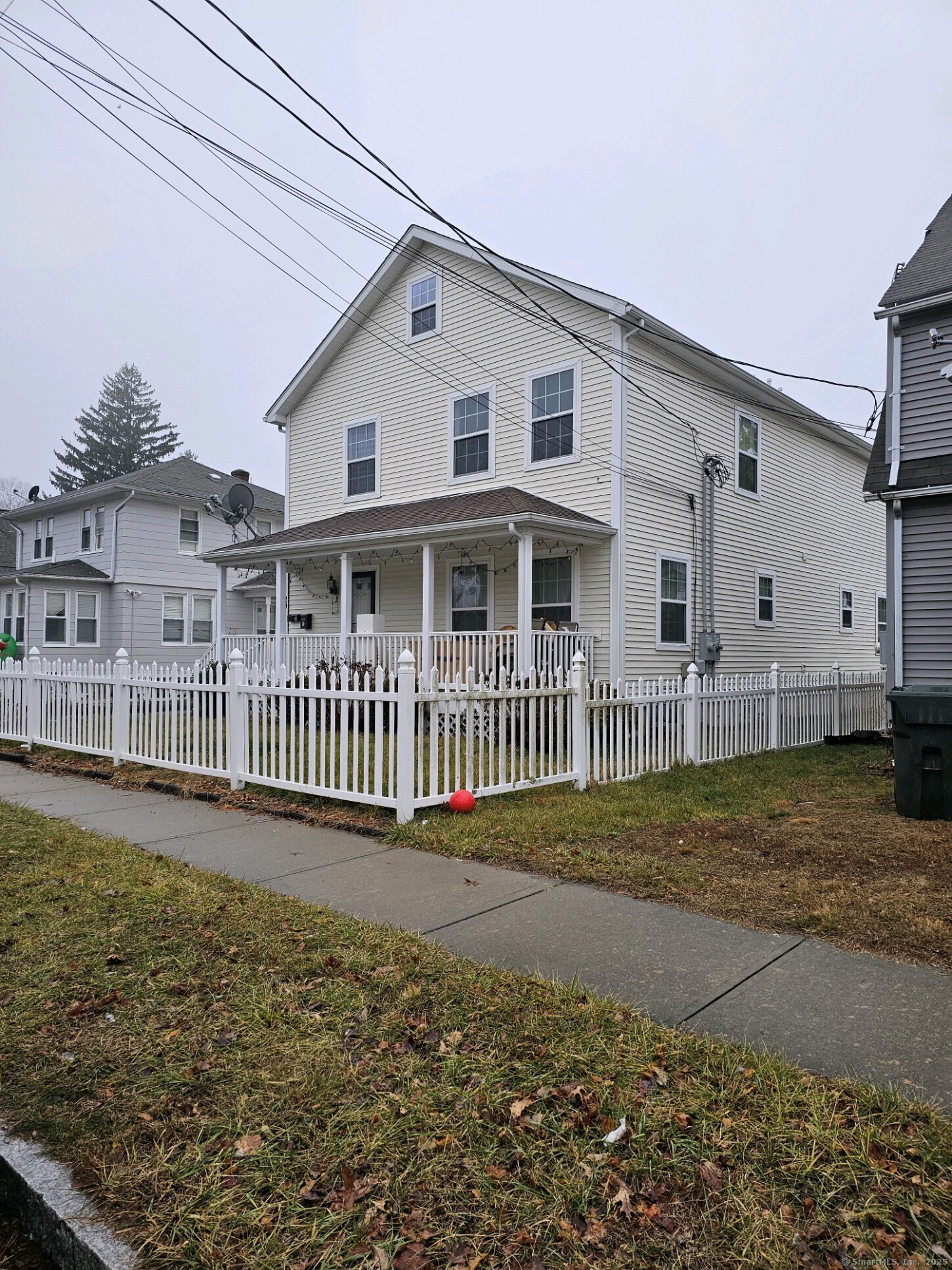 a view of a house with a yard and fence