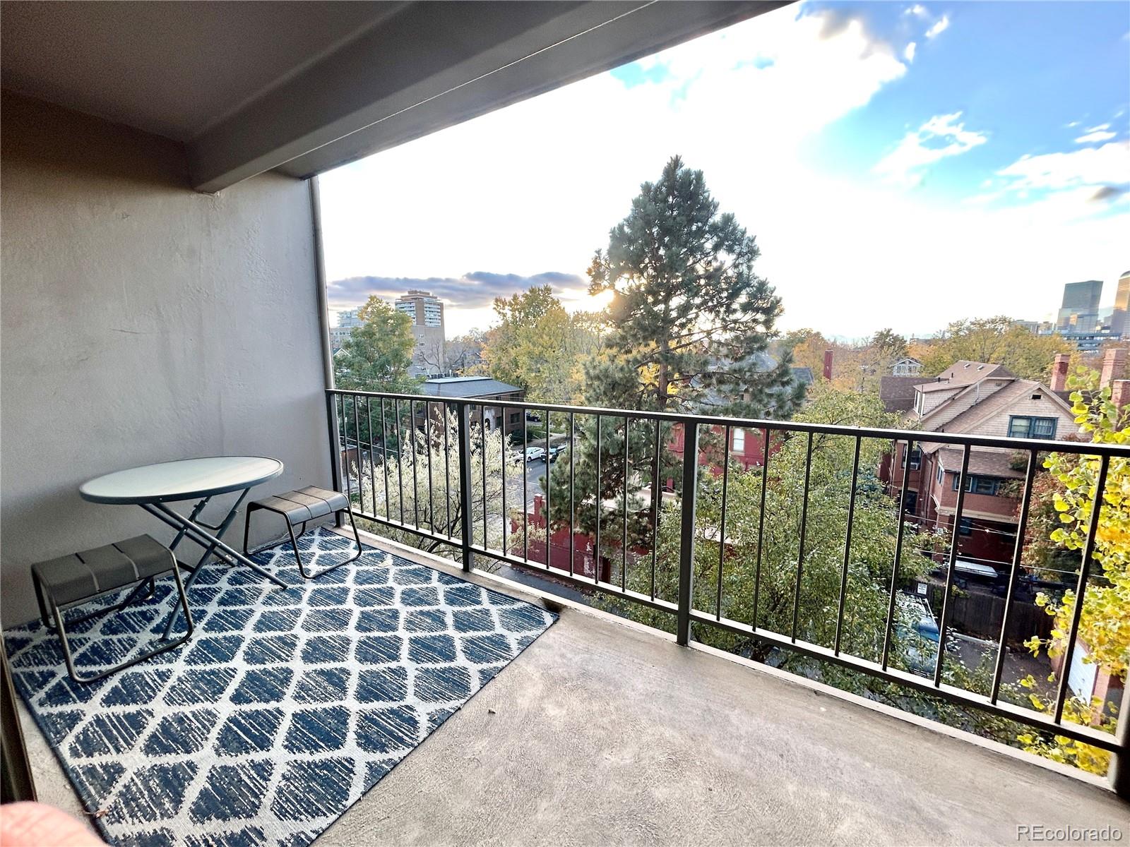 a view of a chairs and table in the balcony