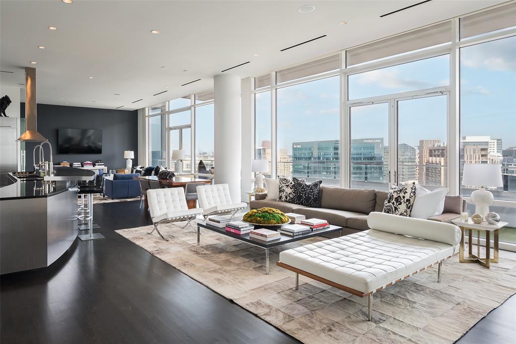 a living room with furniture a flat screen tv and a large window