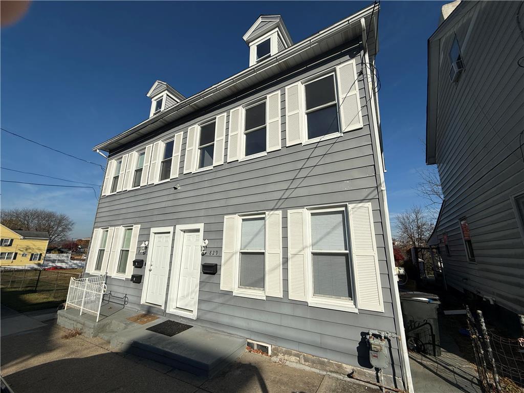 a front view of a house with a large window