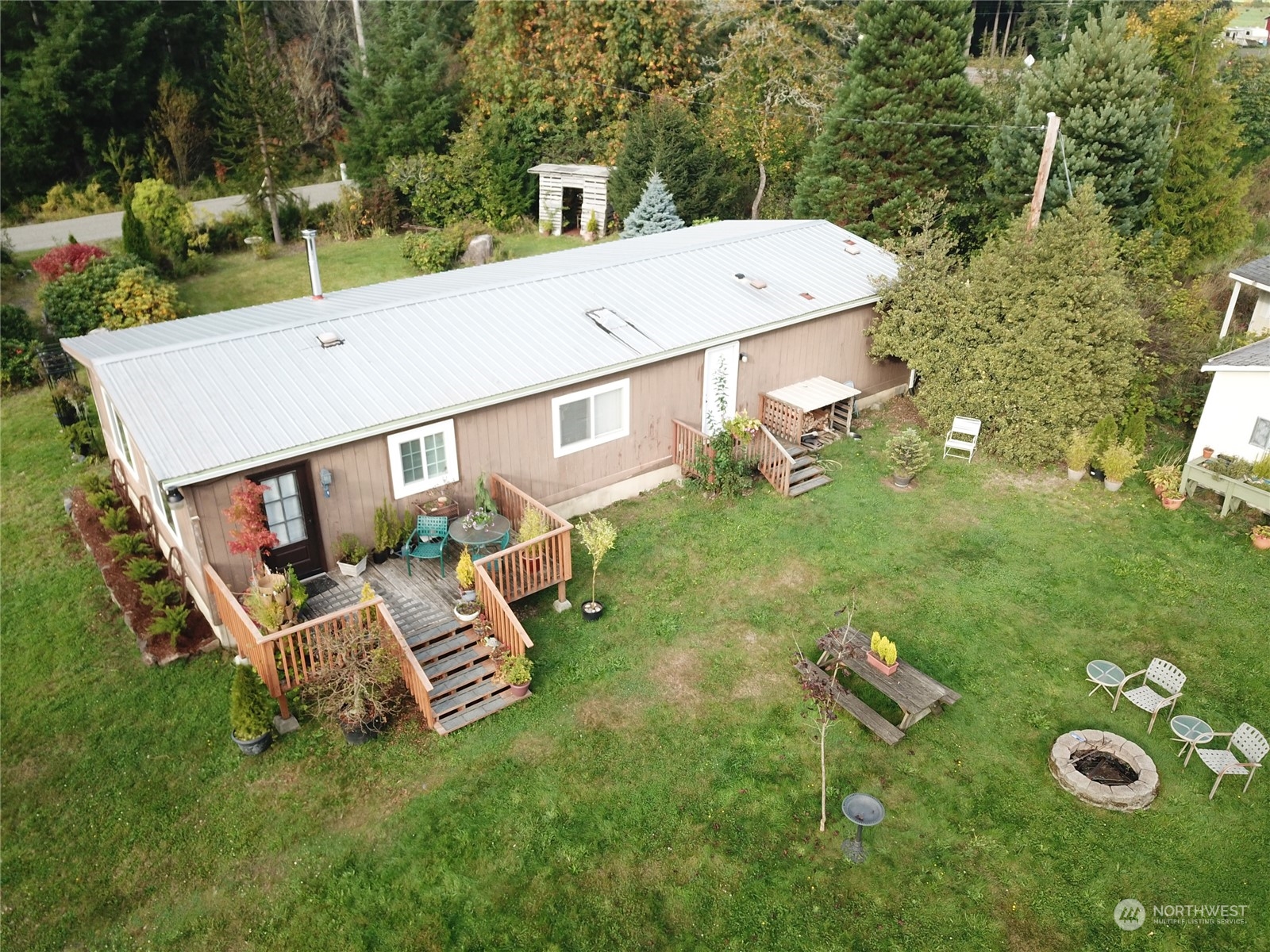 a aerial view of a house with a yard table and chairs