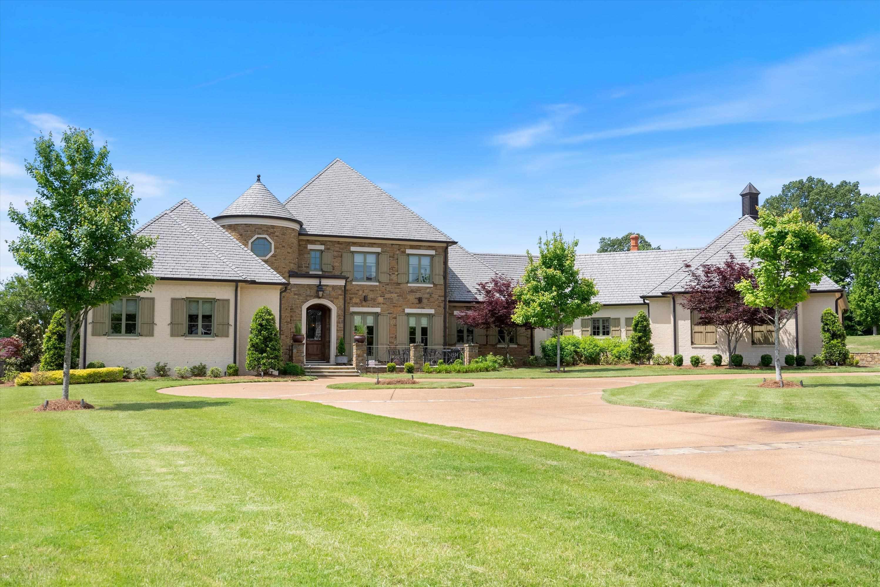 a front view of a house with a yard