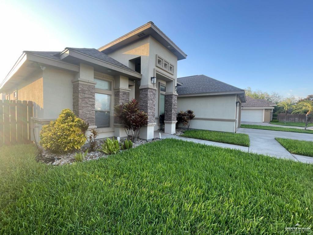 a front view of house with yard and green space