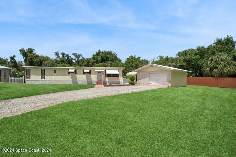 a view of house with backyard and kitchen