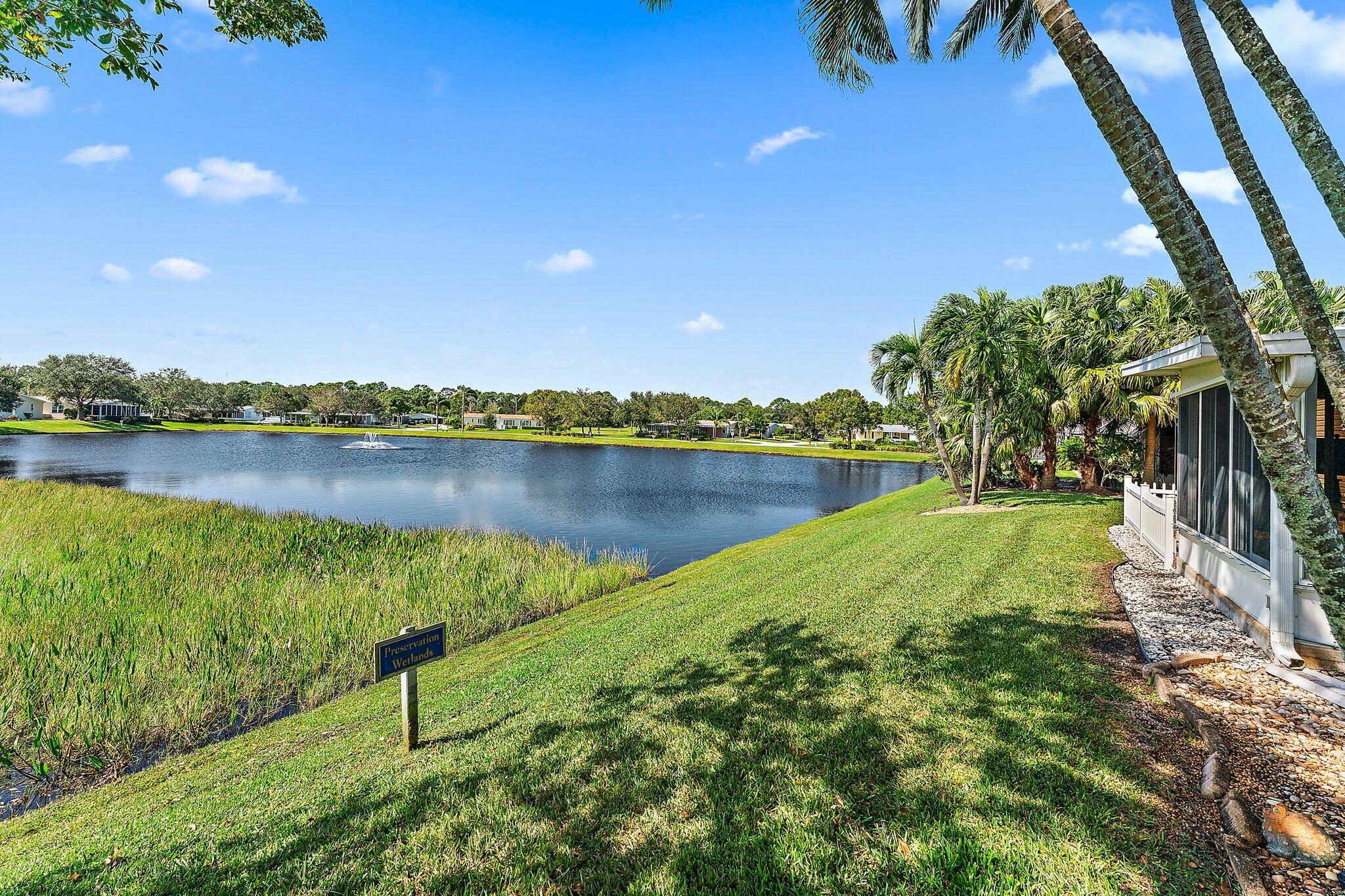 a view of a lake with houses in the back