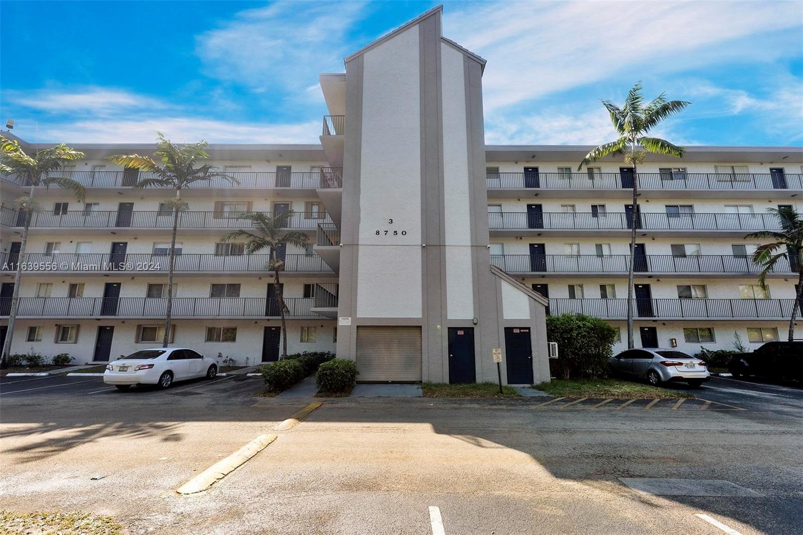 a front view of a building with parking space