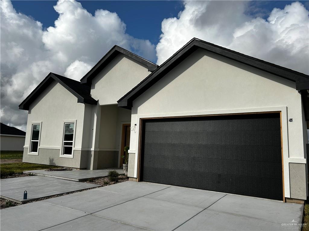 View of front of property featuring a garage