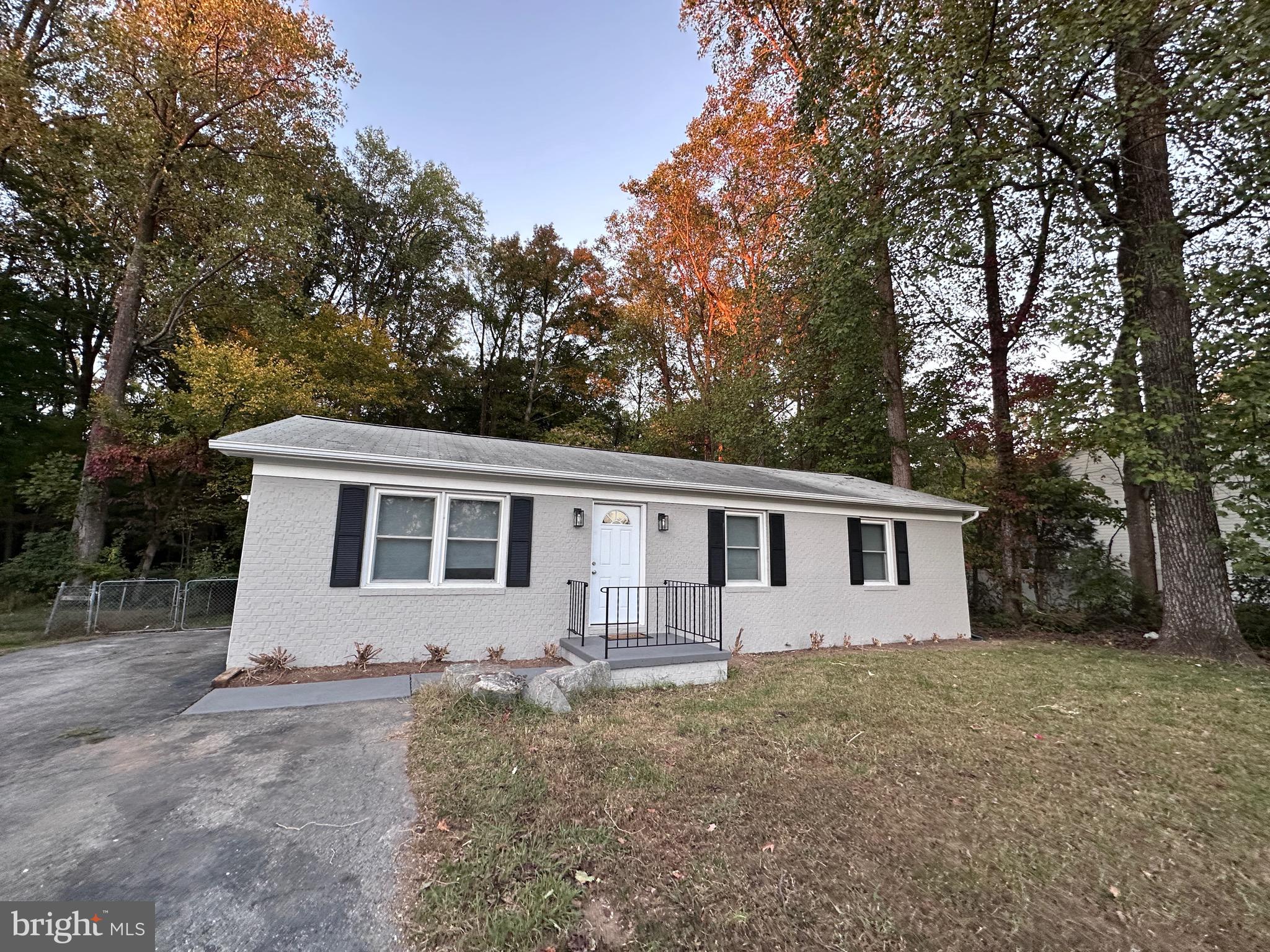 a view of house with a yard