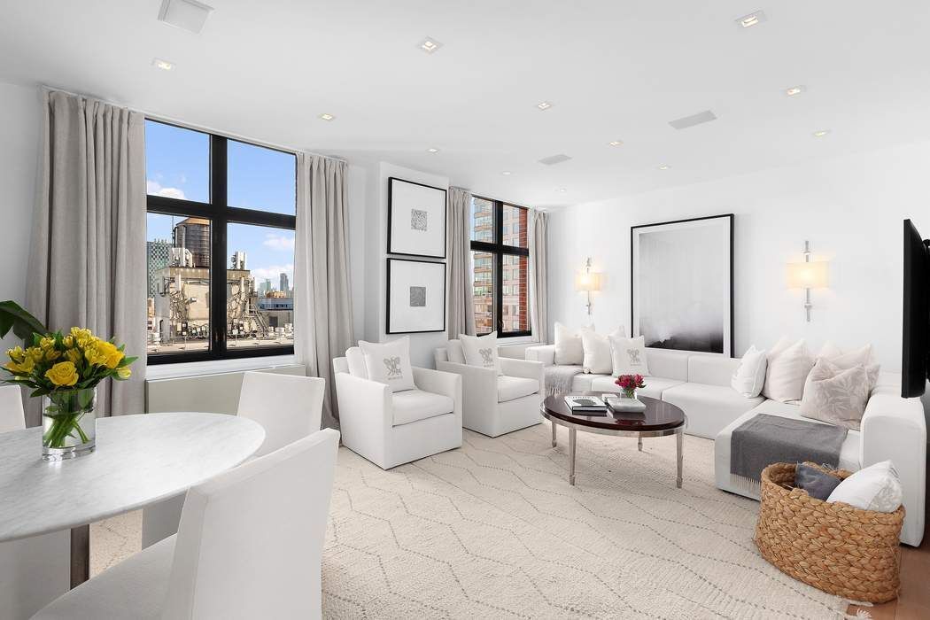 a living room with furniture and floor to ceiling window