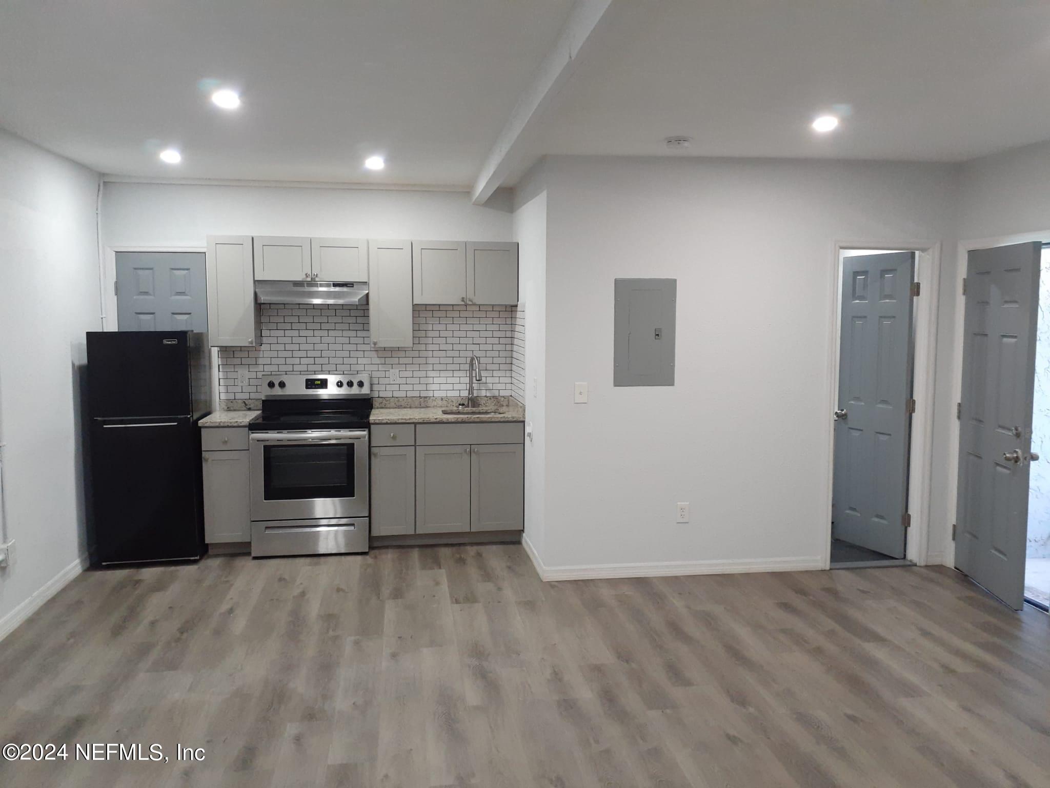 a kitchen with stainless steel appliances a refrigerator and a stove top oven