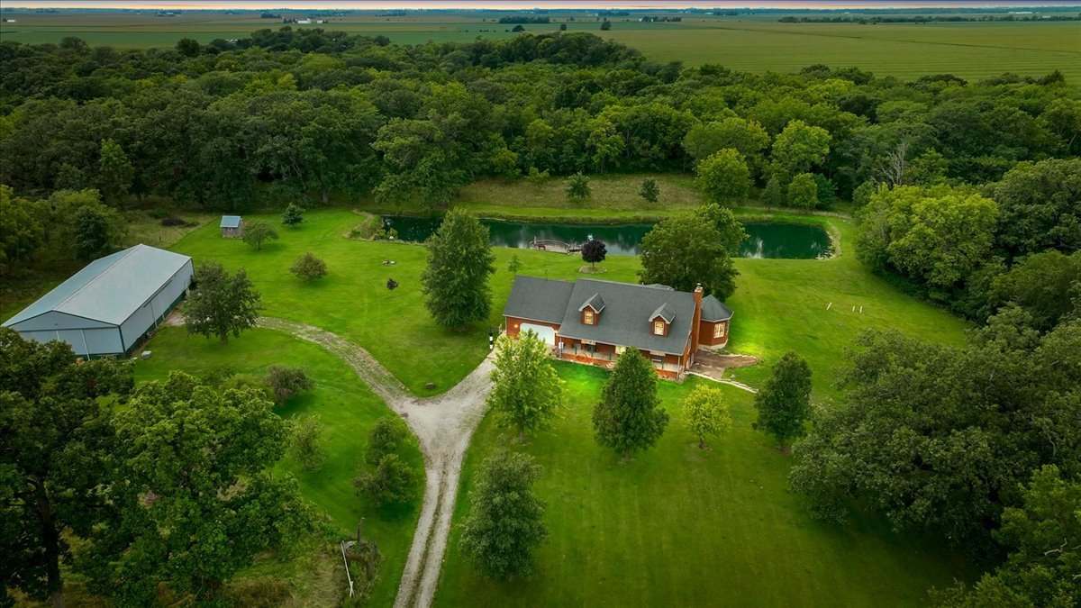 an aerial view of a house with a yard