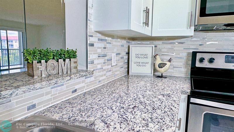 a kitchen with a stove a microwave and cabinets