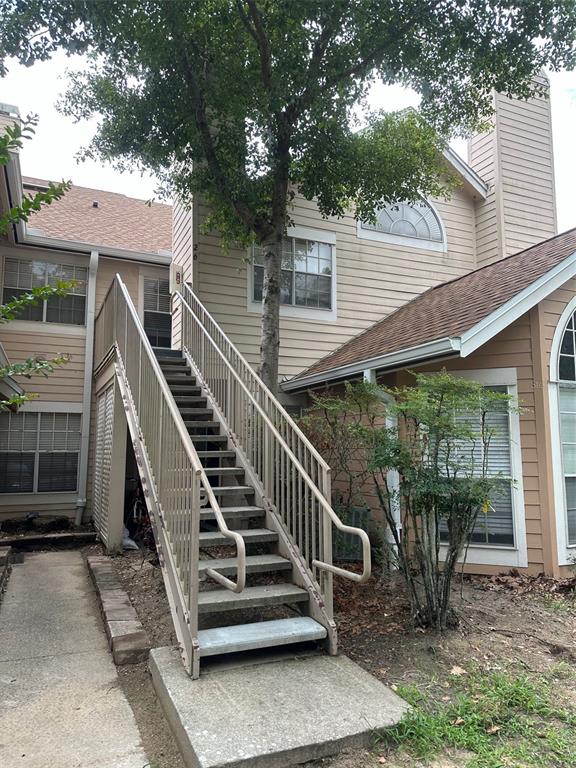 a view of a deck with chairs and a yard with wooden floor and fence