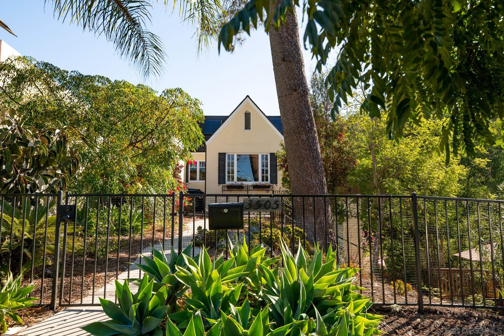 a front view of a house with a garden