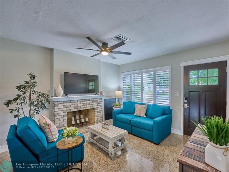 a living room with furniture a window and a fireplace