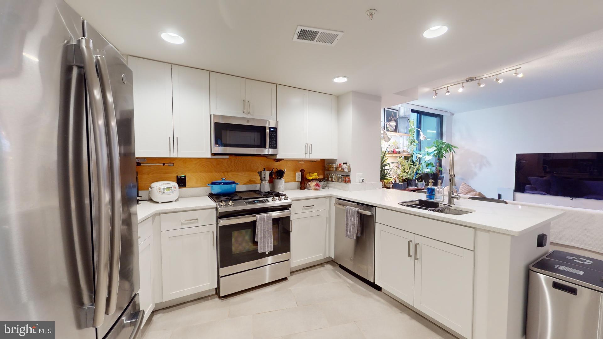 a kitchen with a sink stove and refrigerator