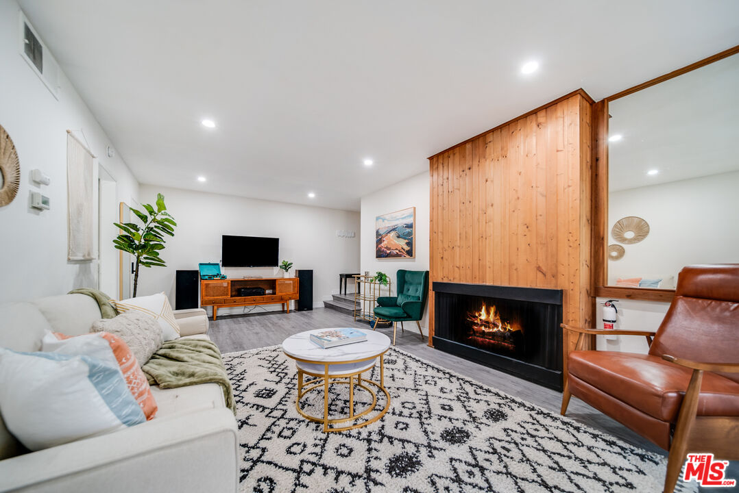 a living room with furniture a rug and a fireplace