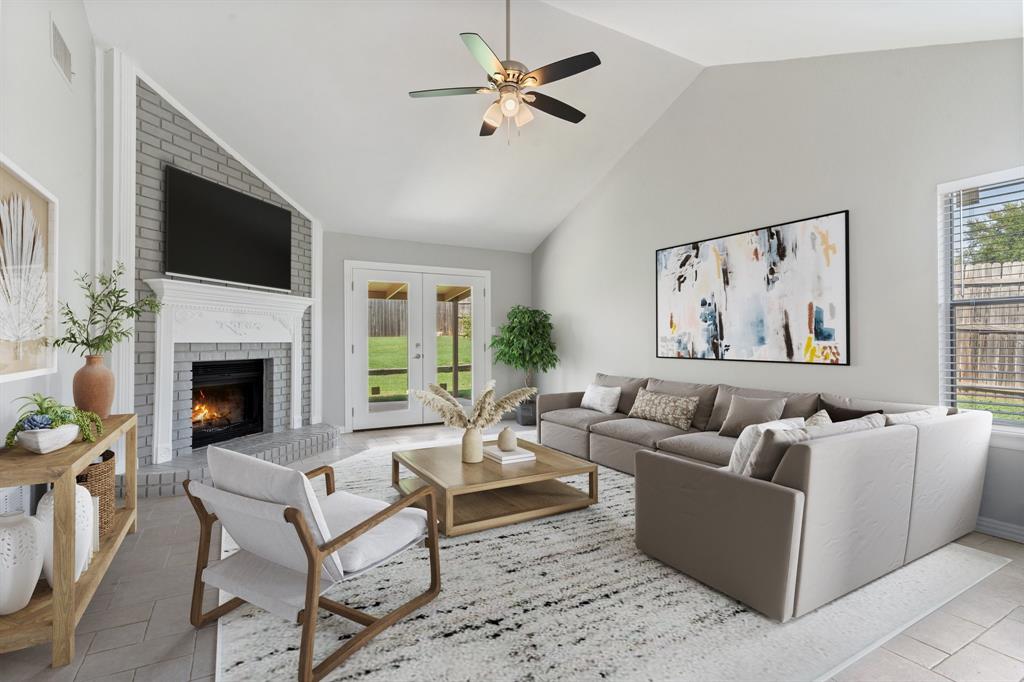 a living room with furniture a flat screen tv and a fireplace