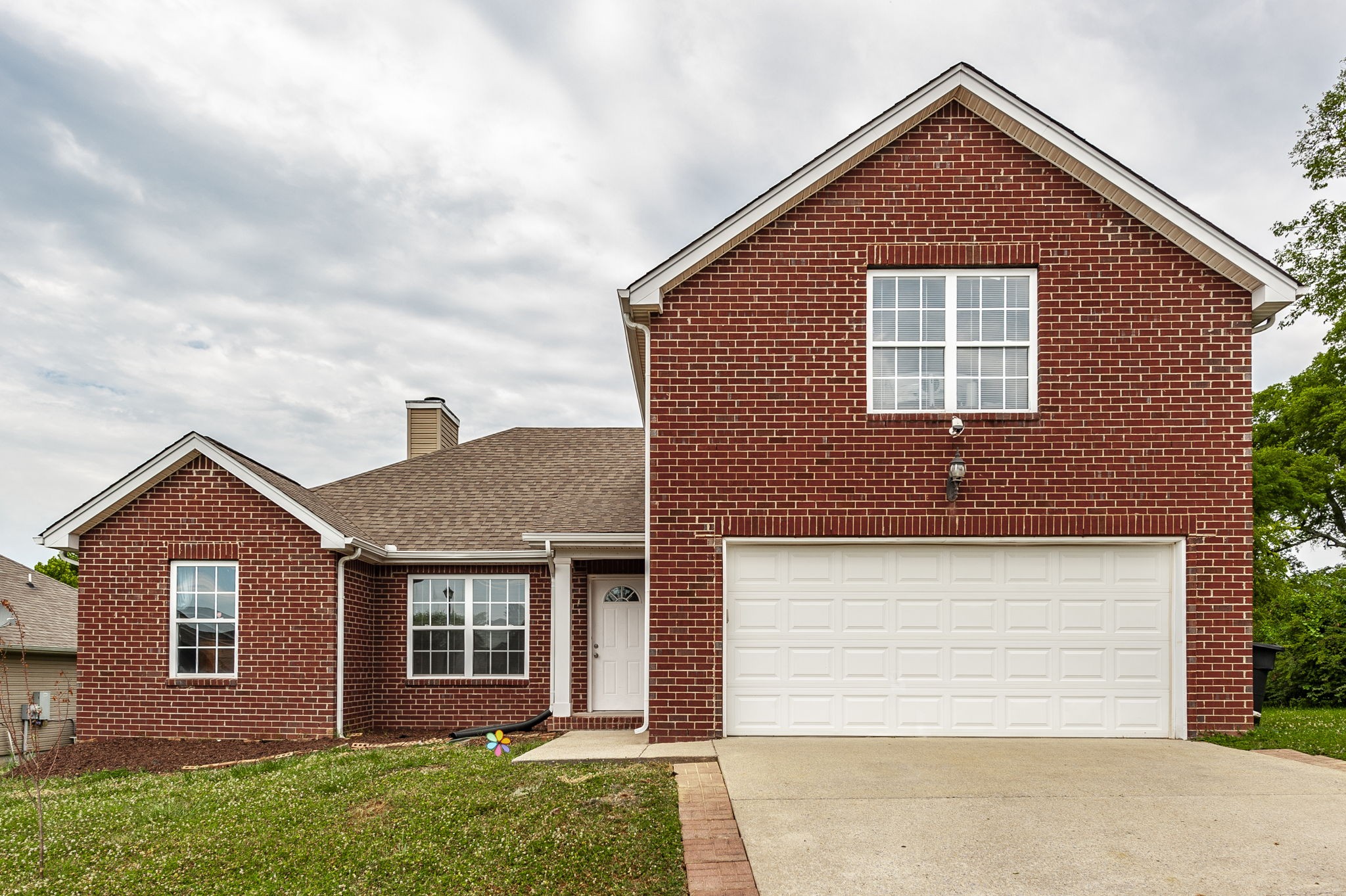 front view of brick house with a yard