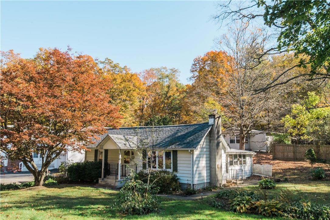 View of front of house with a porch and a front yard