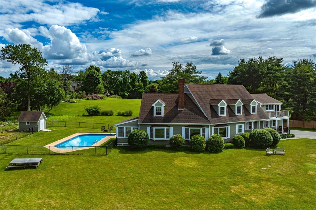 a aerial view of a house next to a big yard