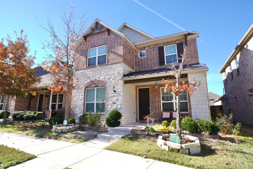 a front view of a house with yard and seating space