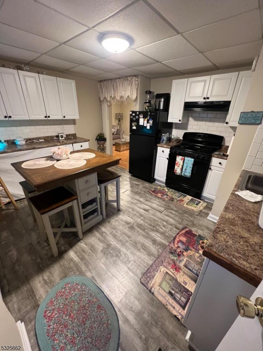 a kitchen with stainless steel appliances granite countertop a sink dishwasher stove and refrigerator