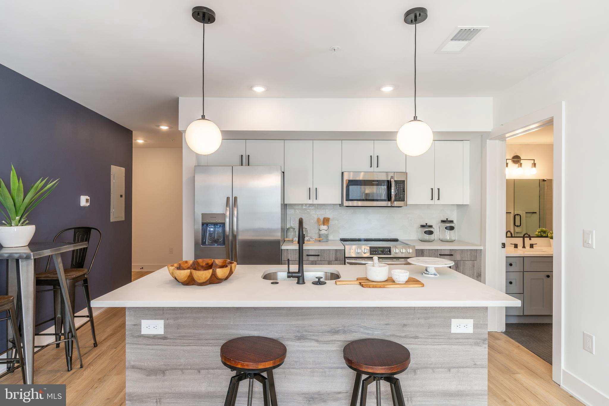 a large kitchen with a table and chairs