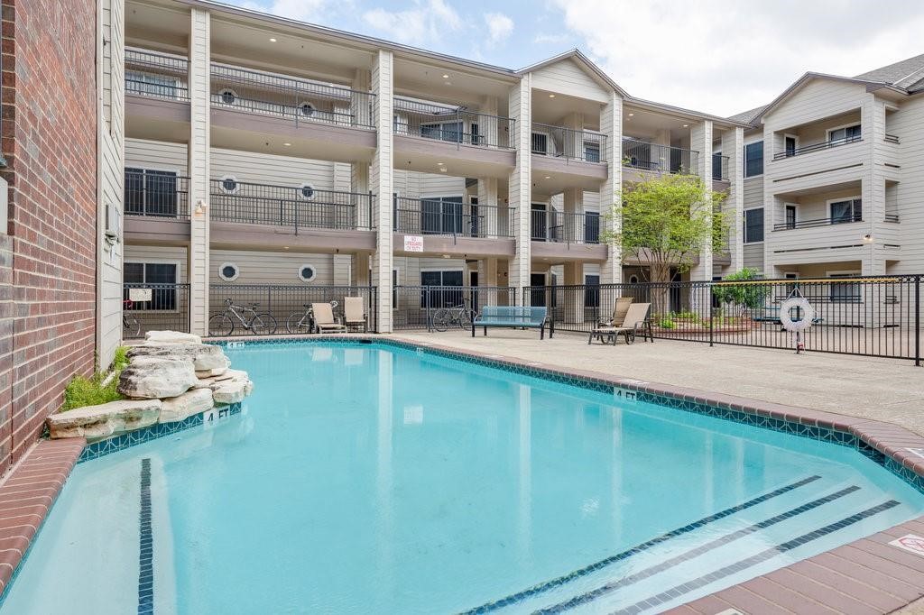 a swimming pool view with a outdoor seating