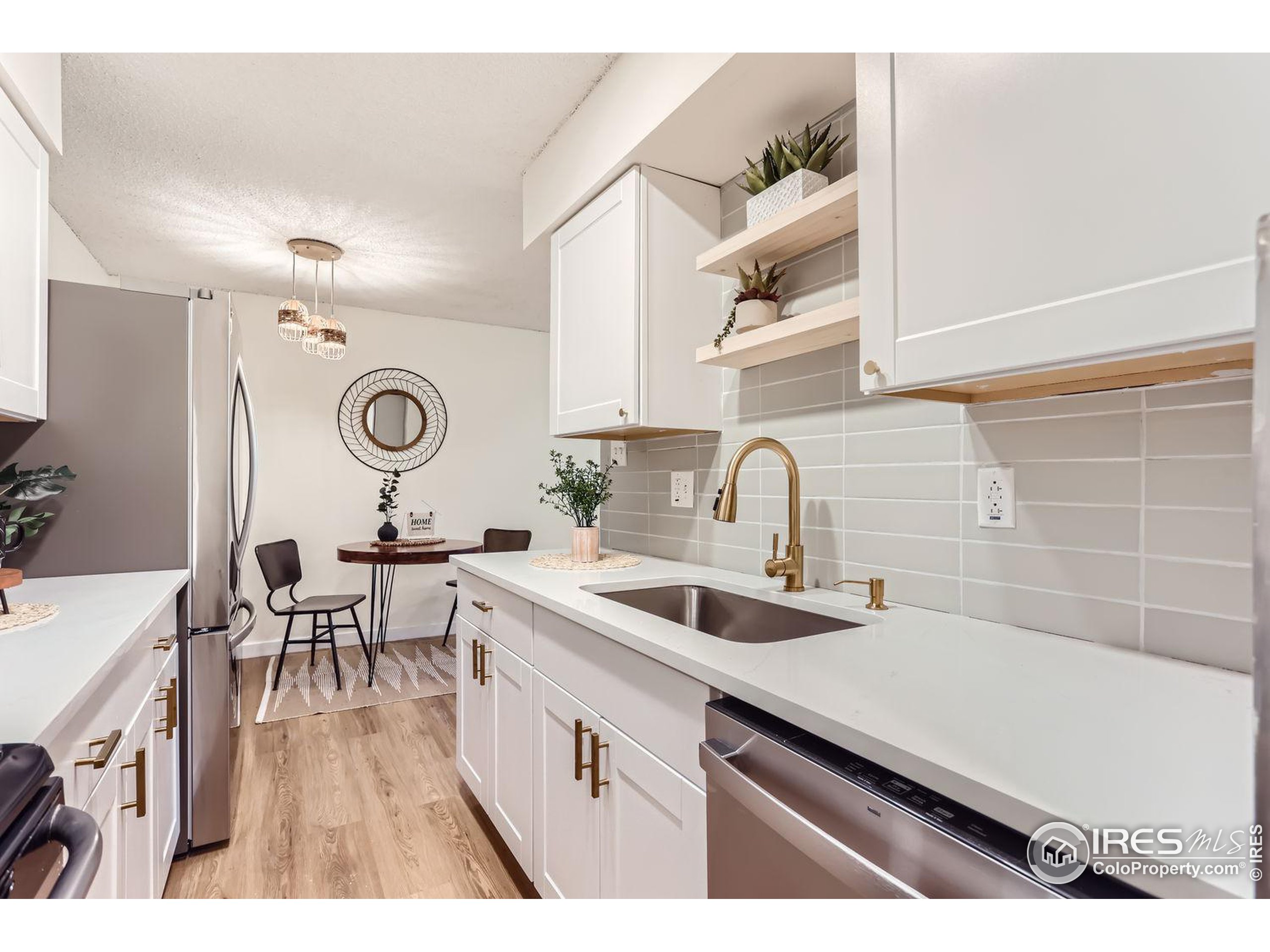 a kitchen with a sink cabinets and wooden floor