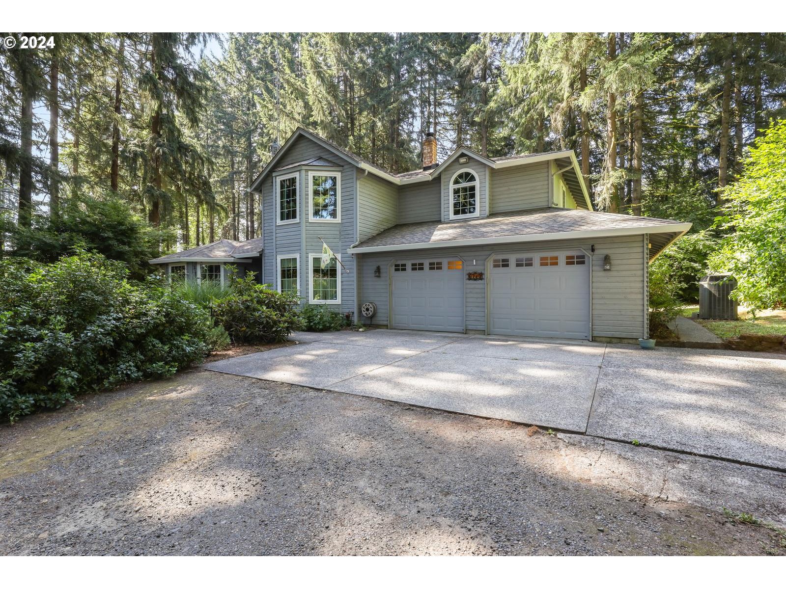 a view of a house with a yard and garage